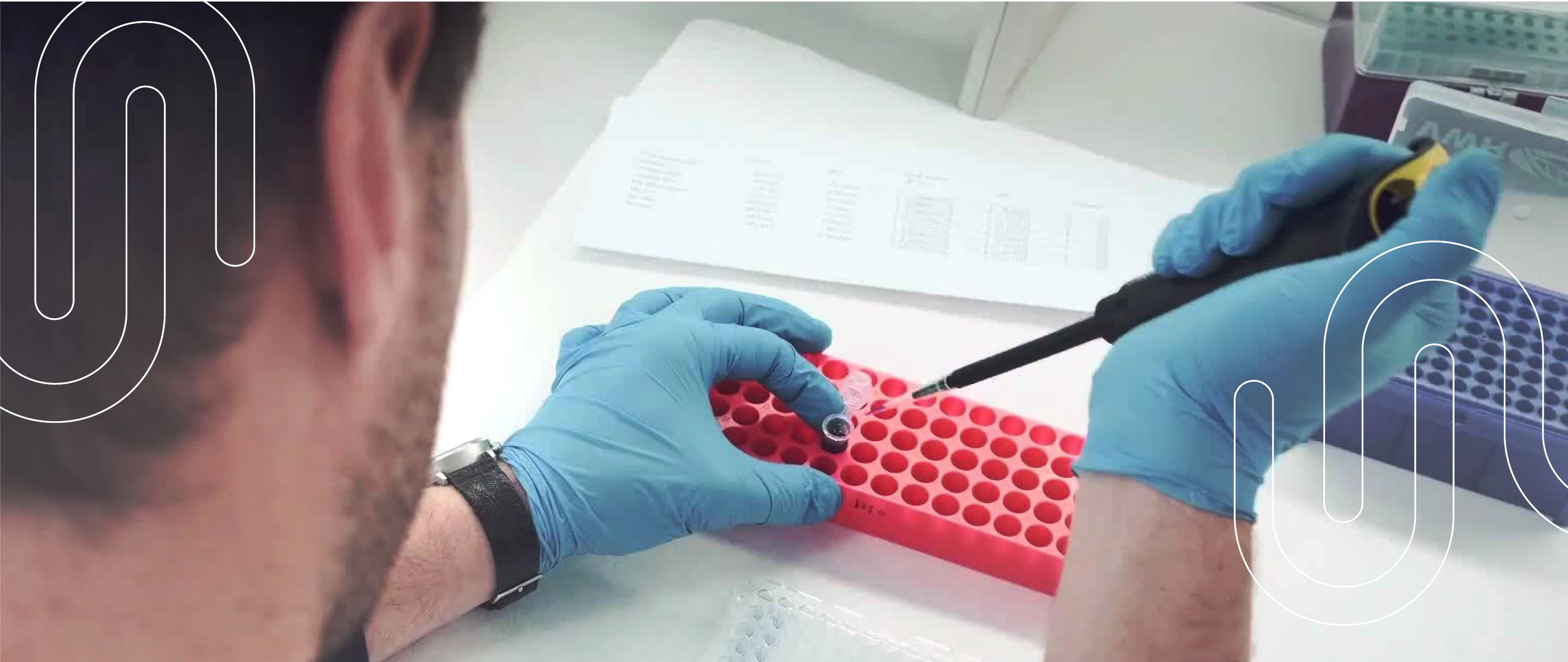 Billede af forsker der sidder og arbejder med pipetter